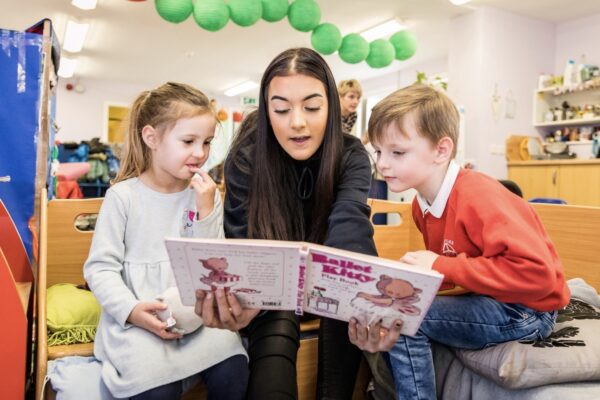 Young person reading to children